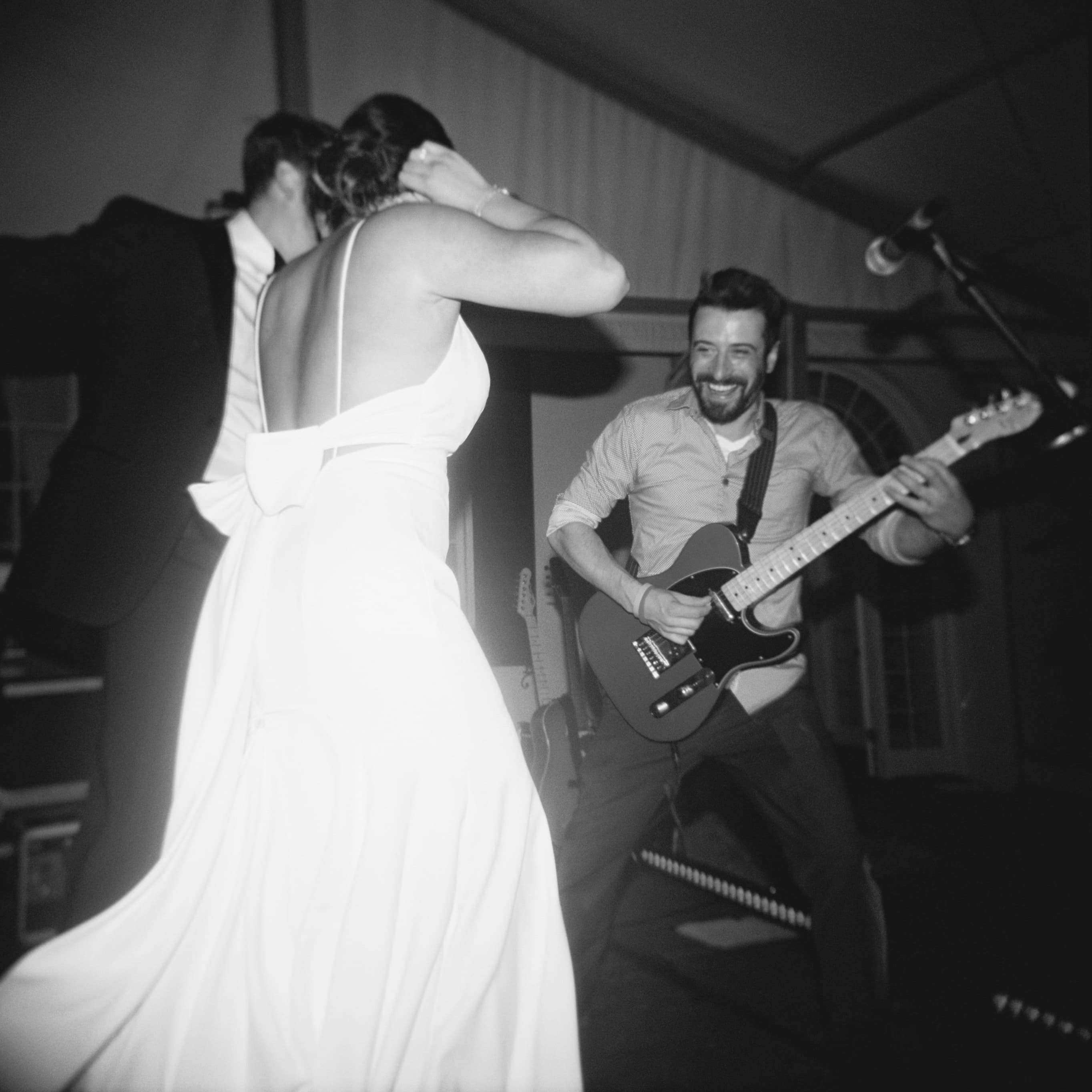 Black and white professional photography of DTSMB performing at Lowndes Grove wedding venue in Charleston